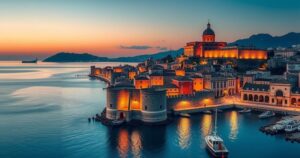 Panoramic view of Cagliari's ancient citadel and coastline with vibrant colors of dusk.